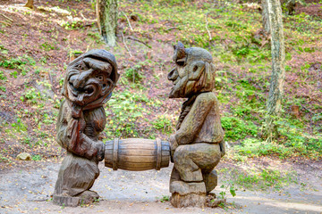 Old wooden sculptures in the forest. Witch Hill park, Lithuania.