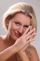 Beautiful young blonde shows off jewelry ring with stone