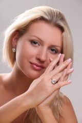 Beautiful young blonde shows off jewelry ring with stone