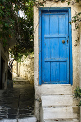 Blue door in the alley of old town Naxos, Greece