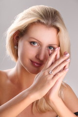Beautiful young blonde shows off jewelry ring with stone