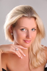 Beautiful young blonde shows off jewelry ring with stone