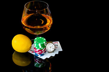 Cards with chips to play poker and snifter brandy