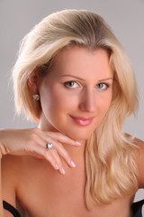 Beautiful young blonde shows off jewelry ring with stone