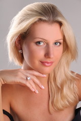 Beautiful young blonde shows off jewelry ring with stone