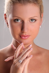 Beautiful young blonde shows off jewelry ring with stone