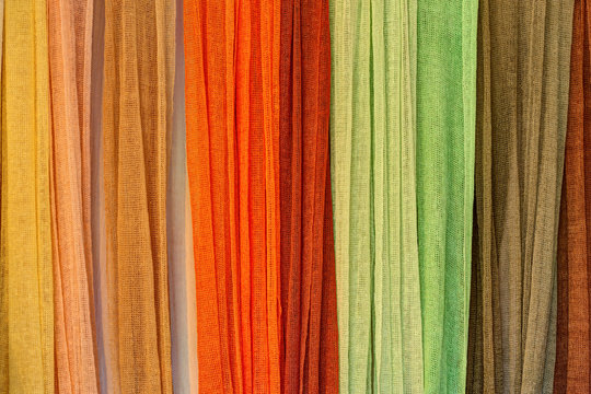 Colorful linen scarfs hanged on the bar.