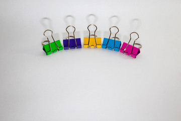 colorful binding clips on isolated background