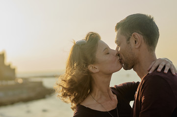 Young couple kissing on a sunset