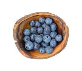 Top view of blueberries in wooden bowl isolated on white