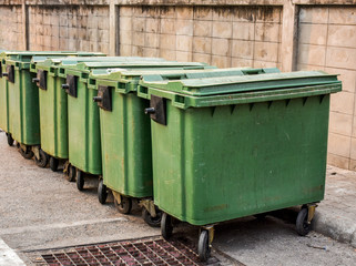 Stack of huge trash bins in front of the market place