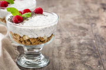 Chia yogurt with raspberries on wooden background

