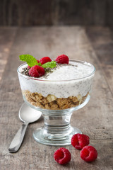 Chia yogurt with raspberries on wooden background

