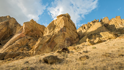 Unusual shaped rocks on the background of blue sky. Beautiful landscape of yellow sharp cliffs. Smith Rock state park, Oregon