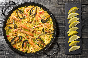 Spanish paella on a wooden table.