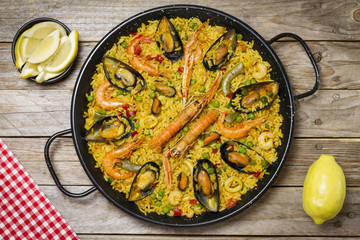 Spanish paella on a wooden table.