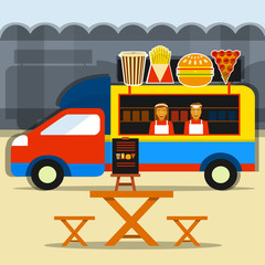 Food truck festival. Street food truck with seller and seating areas.