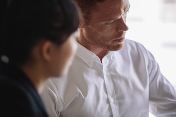 Young man in meeting with female colleague