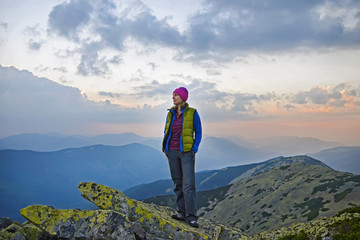 Obraz premium Smiling young woman on the top of mount Great Sivulja ,Carpathian ,Ukraine