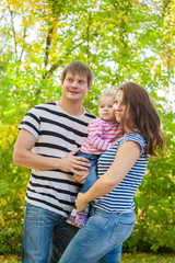 Fototapeta premium happy family in the same clothes for a walk in the park in autumn
