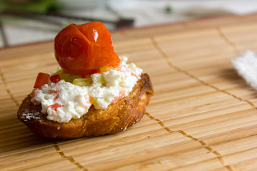 Fresh and tasty crostini. Goat cheese and cherry tomato crostini.