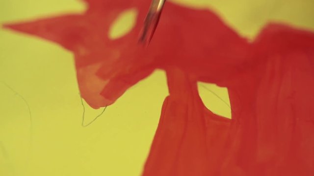 The girl draws a picture paints in classroom