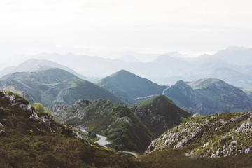 Sunset in the mountain natural landscape park. Green valley on background dramatic sky and clouds. Panorama  horizon view of scenery  foggy hills Northern Spain alps. Travel mockup concept in evening