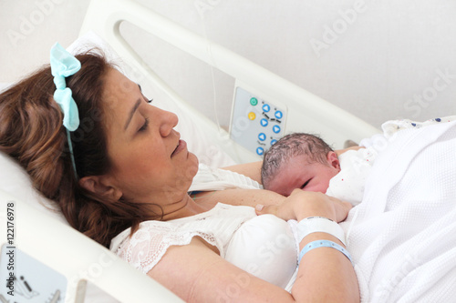 Mother breastfeeding her newborn baby in hospital Mother breastfeeding her newborn baby in hospital
