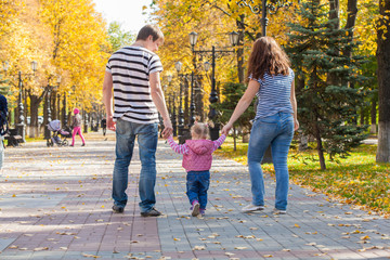 happy family in the same clothes for a walk in the park in autumn