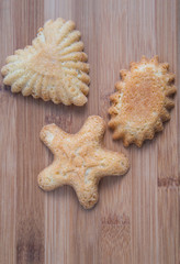 Sandbakkel cookies on a bamboo wooden cutting board