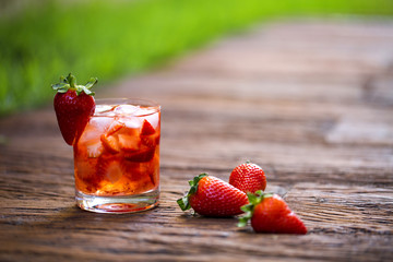 Fresh made Strawberry Caipirinha on wooden background