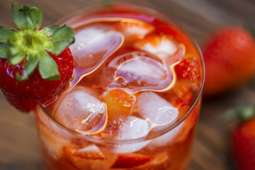 Fresh made Strawberry Caipirinha on wooden background