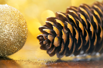 Christmas card template of golden pine cone and decoration bauble ball