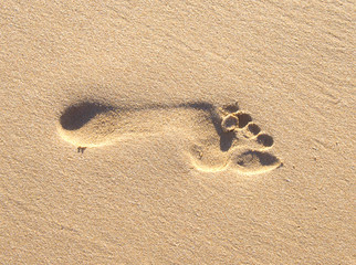 Fototapeta na wymiar Fußabdruck in Sand, Hintergrund