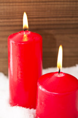 lit candles on snowflakes with wooden background