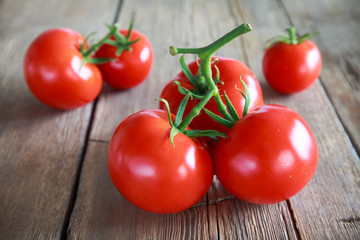 Sweet tomatoes isolated on wooden background