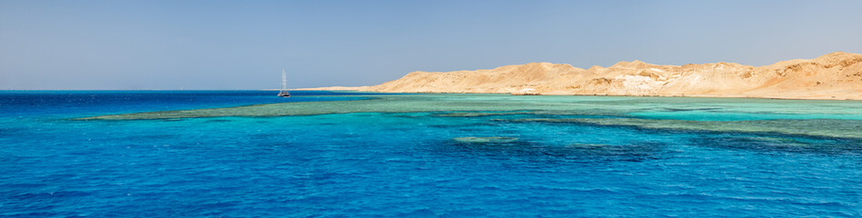 Fototapeta na wymiar panorama with yellow seashore and emerald water