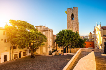 Central square with tower and church in Antibes coastal village on the french riviera in France