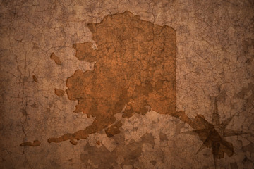 alaska state map on a old vintage crack paper background