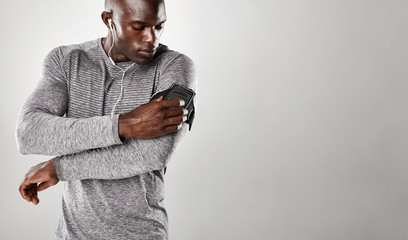 African male listening to music on mobile phone