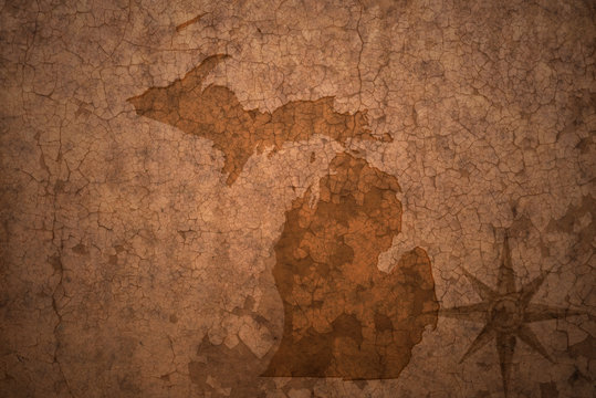 michigan state map on a old vintage crack paper background