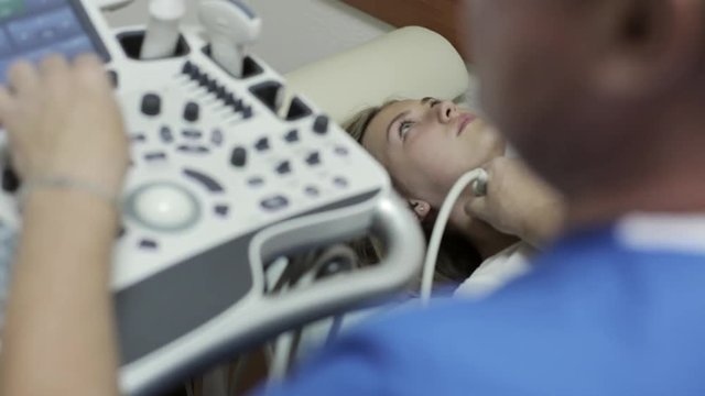 Doctor taking a sonogram of patients neck in the hospital
