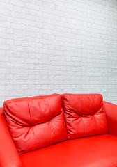 red sofa and white brick wall