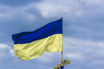 The national yellow and blue flag of Ukraine over the sky  clouds