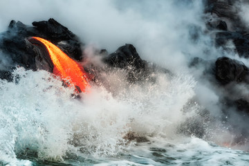 Molten lava flowing into the Pacific Ocean on Big Island of Hawaii, USA