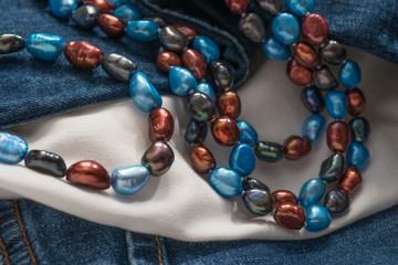 Bead Necklace on White Cloth and Denim