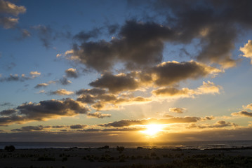 Dramatic sunset at Atlantic ocean with clouds.