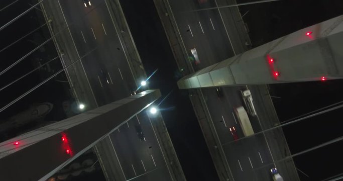 Cinematic aerial night view of Obuhovskiy bridge with the illuminated light from cars, Saint Petersburg, Russian Federation