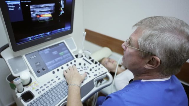 Doctor taking a sonogram of patients neck in the hospital