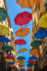 Fototapeta na wymiar Antique street decorated with colored umbrellas.